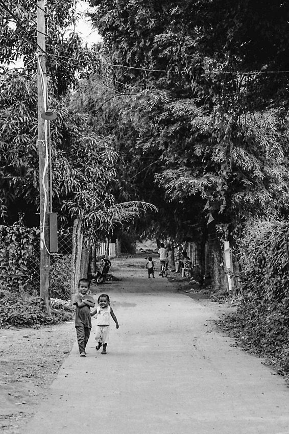 Little kids walking road