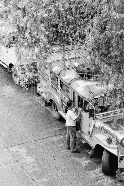 Woman standing by jeepney