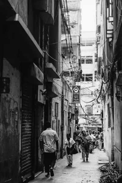 Dim alleyway between buildings in Dhaka