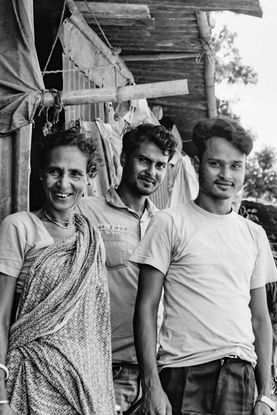 Family standing in front of house
