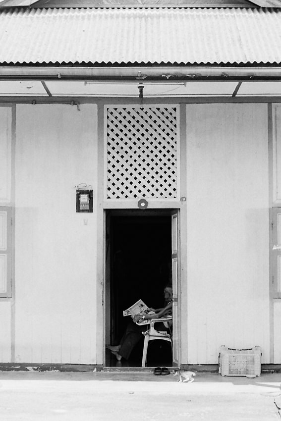 Man reading newspaper at entrance