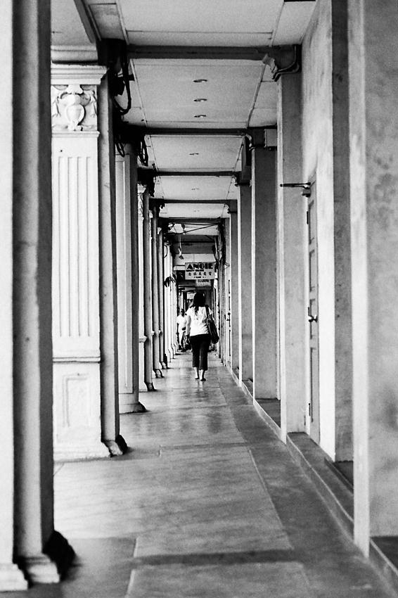 Woman walking straight passageway