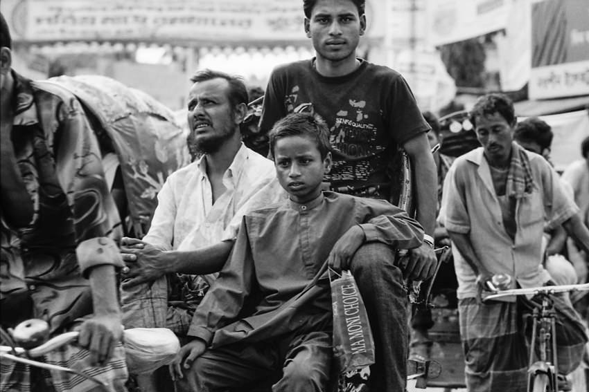 Three passengers on same cycle rickshaw