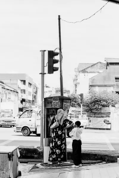 Mother and her son at pay phone