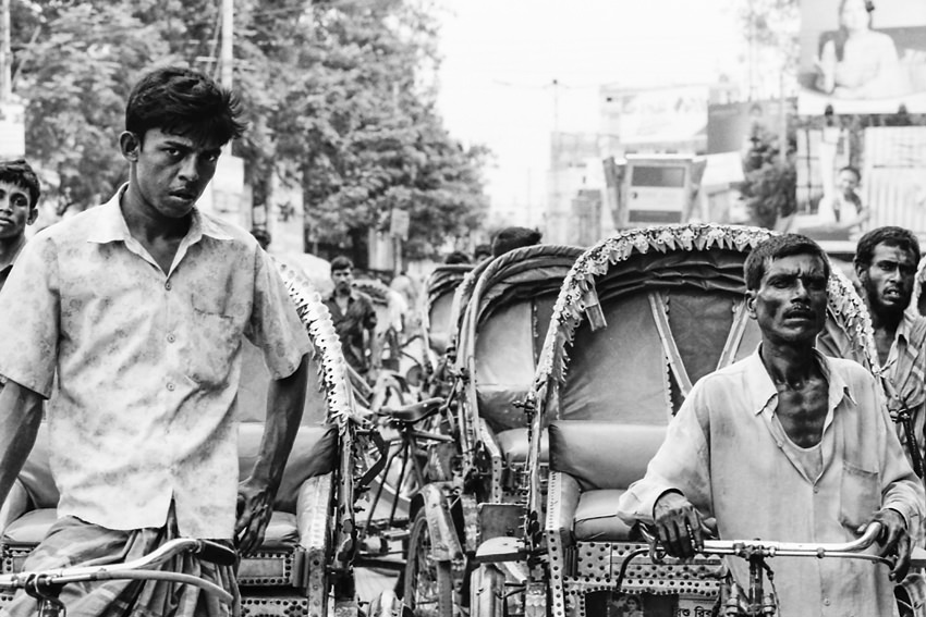 Cluster of cycle rickshaw being stopped at traffic light