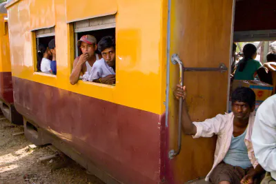 Two men by car window of a train