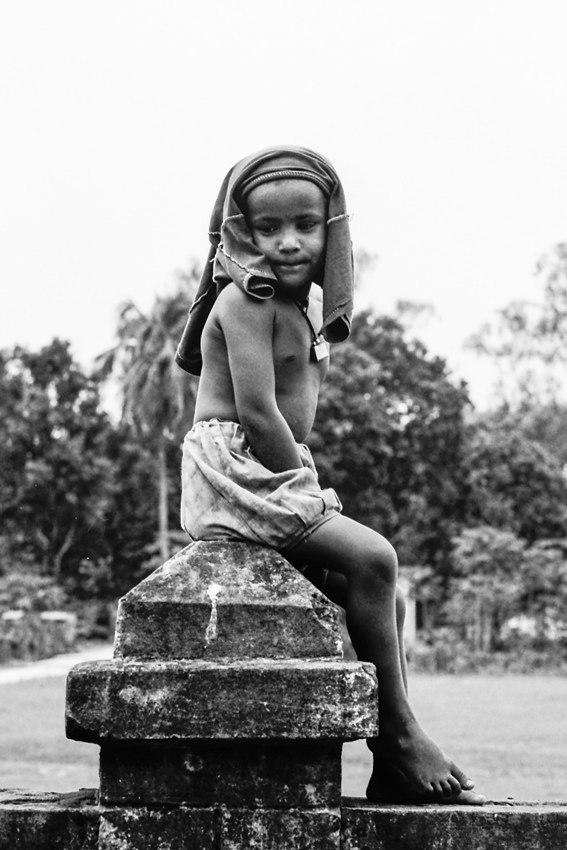 Boy sitting on ledge