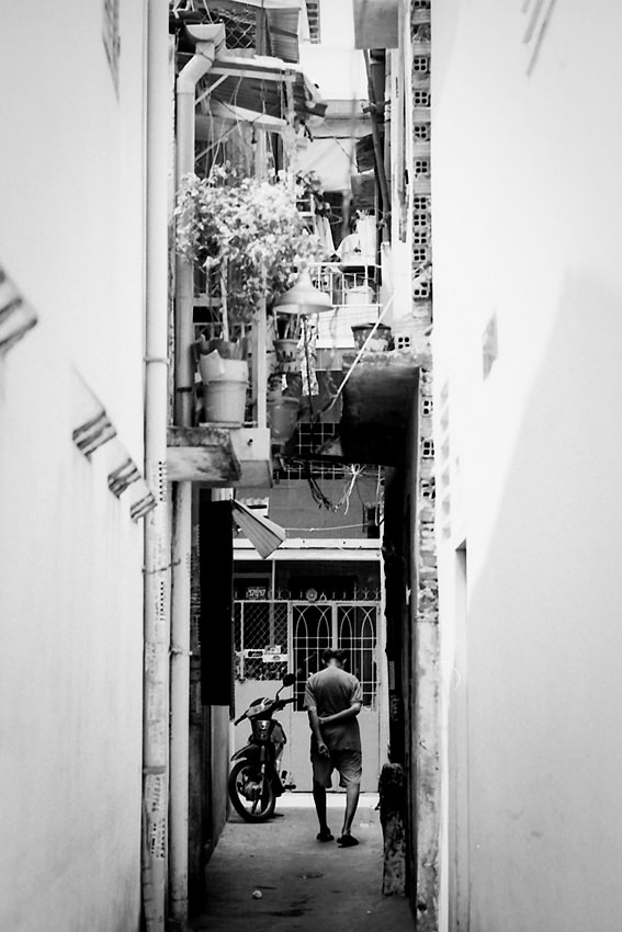 Drooping man in dim lane
