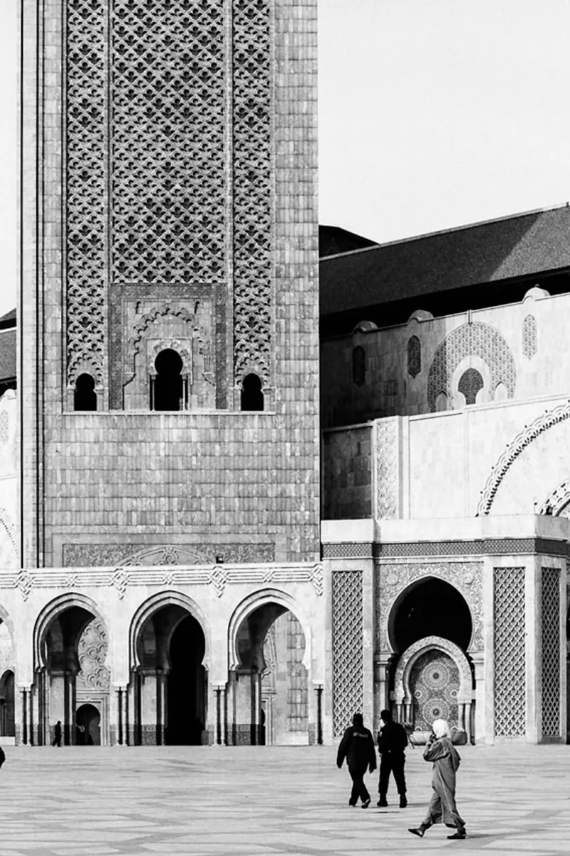 Figure walking square in front of Grande Mosquée Hassan II