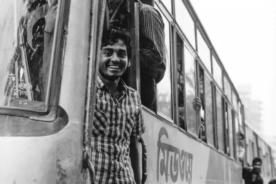 Bus conductor standing at platform