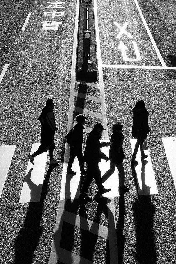 Silhouette crossing street