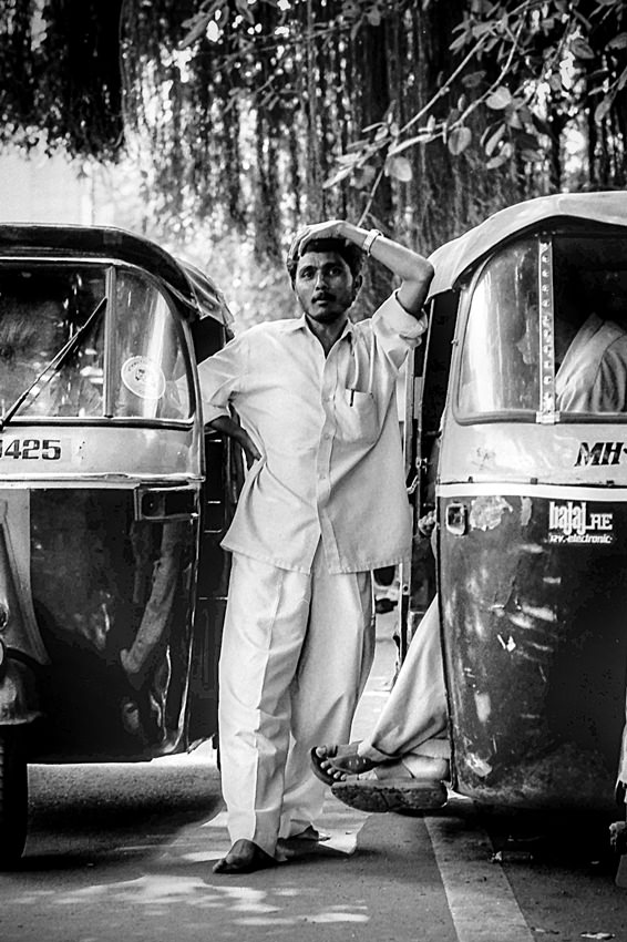 Man between auto rickshaws