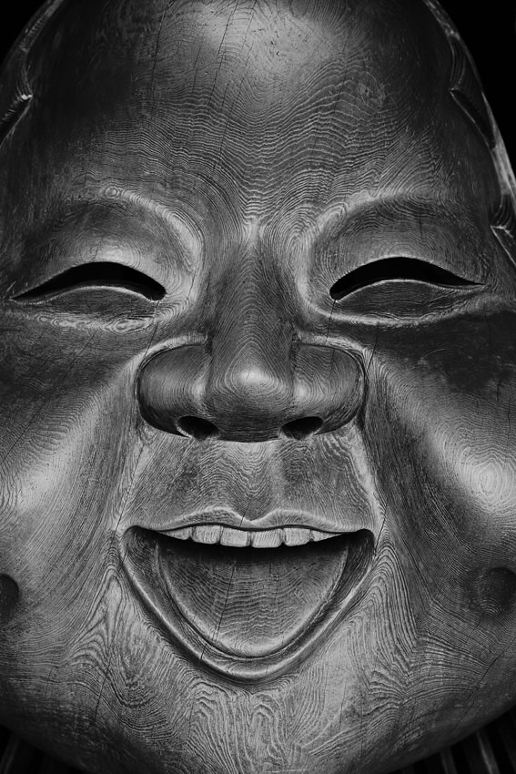 Wooden mask smiling