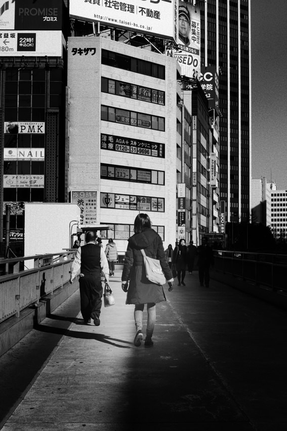 Woman on pedestrian bridge