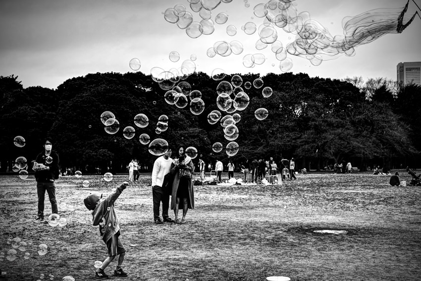 boy standing against soap bubbles