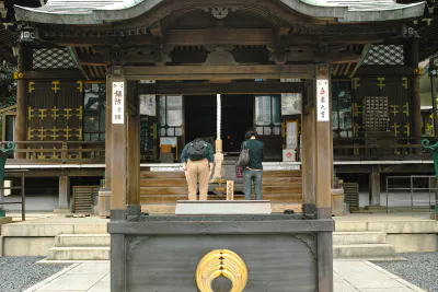 People praying at the main hall of Toyokawa Inari