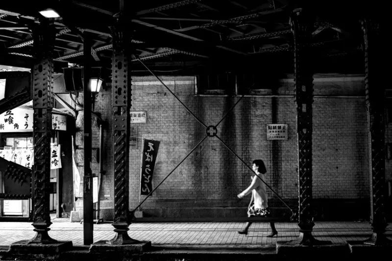 woman walking railway underpass