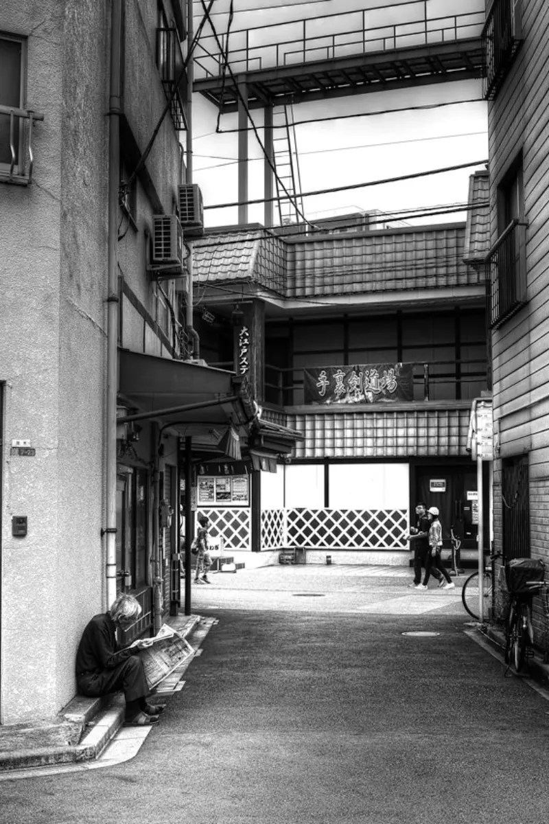 Man reading newspaper in lane