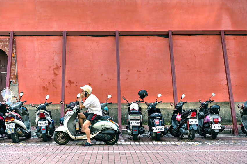 Motorbikes in front of red wall