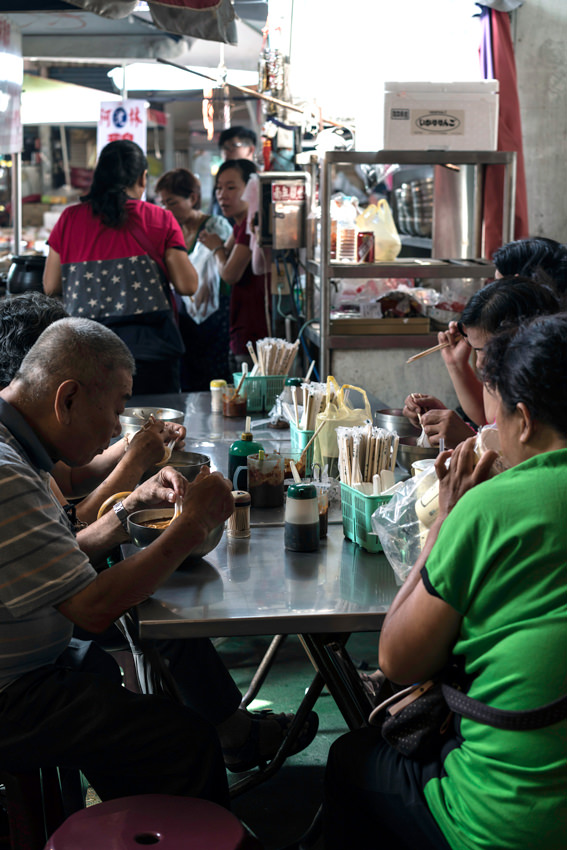 People eating in a food stall