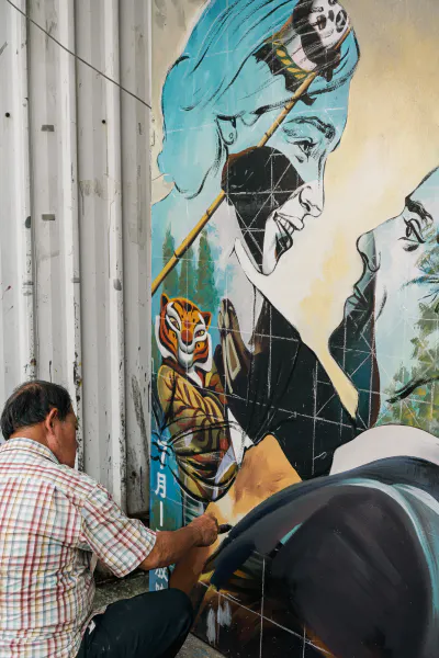 Man painting the billboards for the movie