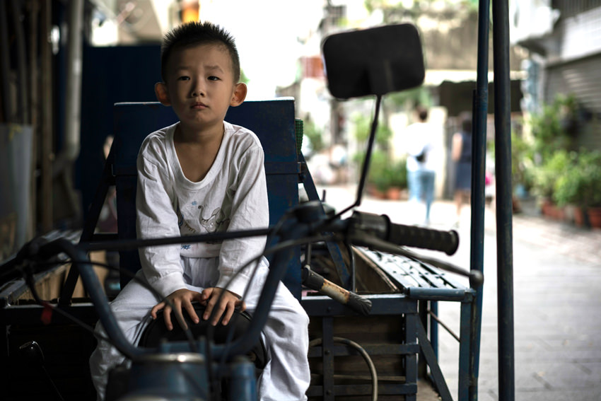 Little boy was on the seat of motorcycle