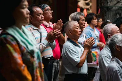 people joining hands in prayer