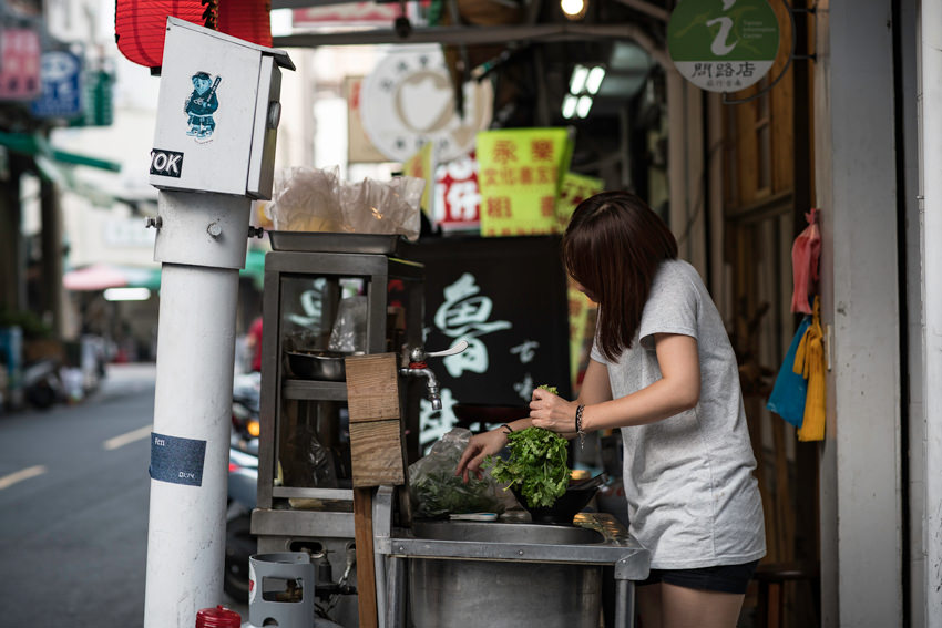young woman grabbing greens