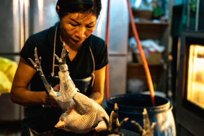 Female butcher and chicken