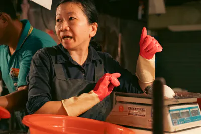 Female fishmonger and weighing machine