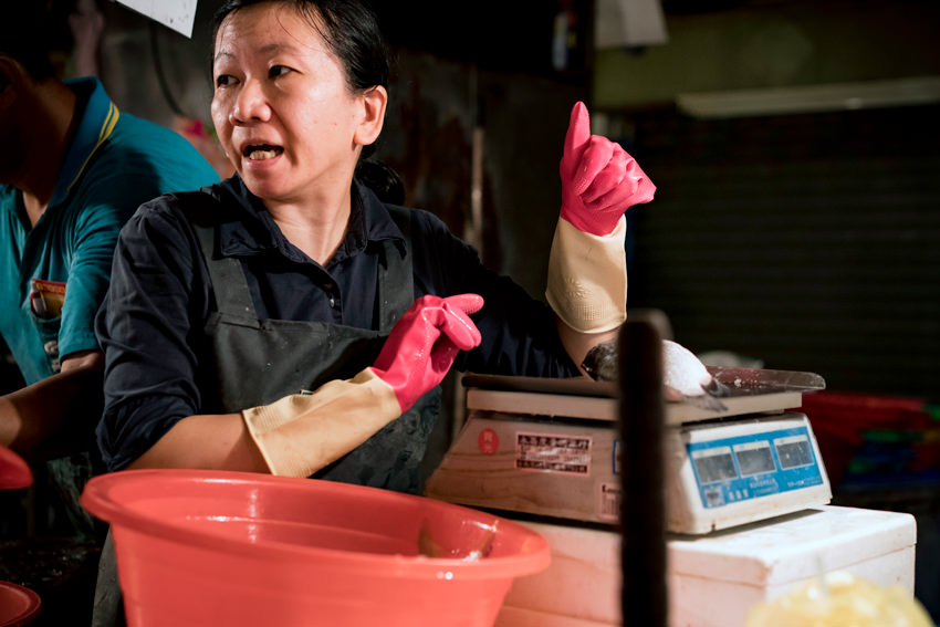 Female fishmonger and weighing machine