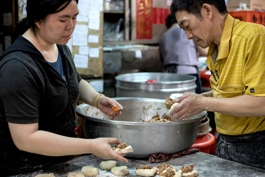 Man and woman making meat buns