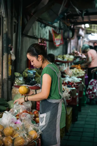 young woman grabbing pomelo