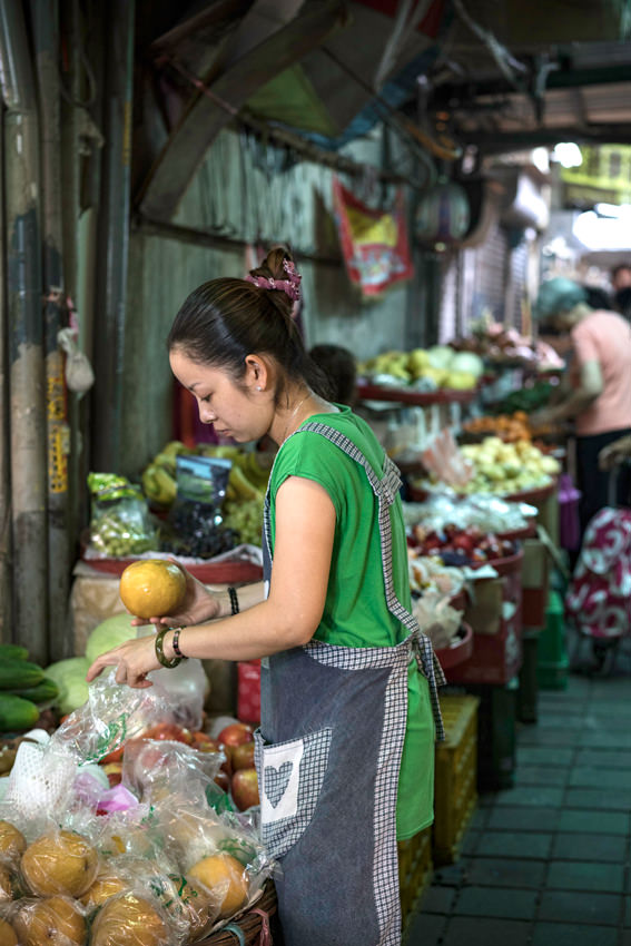 young woman grabbing pomelo