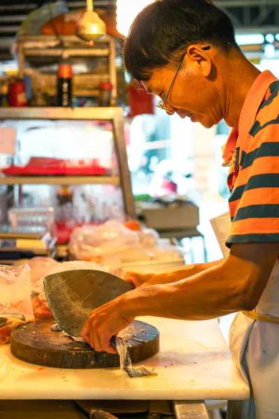 Fishmonger holding unusual type of kitchen knife