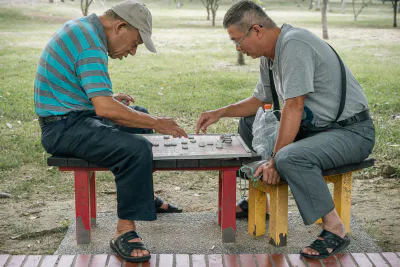 Men playing Chinese chess in a park