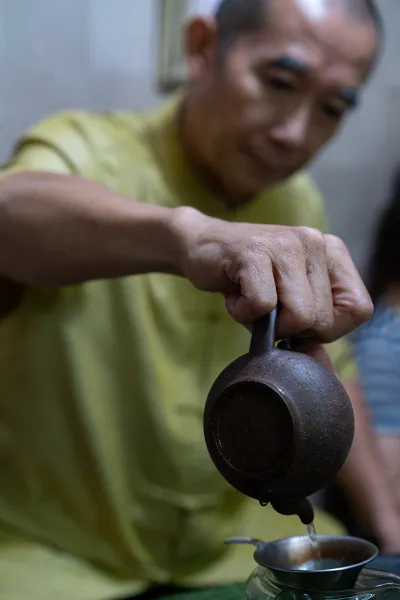 man pouring out Chinese tea