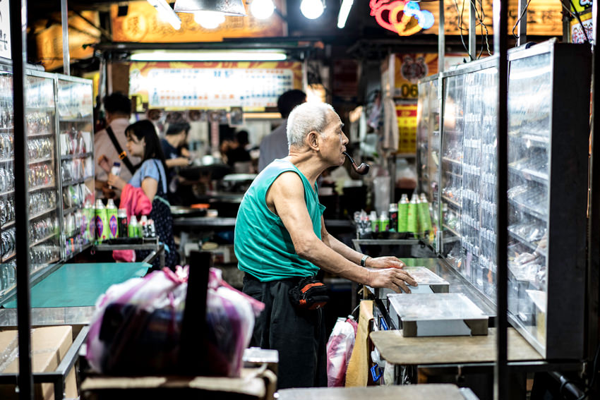 old man standing with a pipe