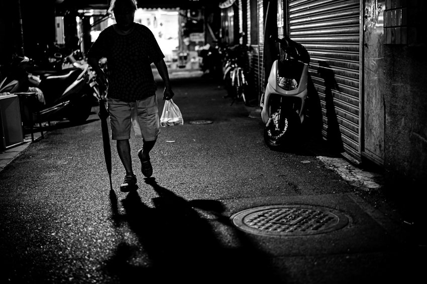 silhouette carried umbrella and plastic bag