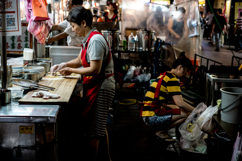 woman cooking in food stall