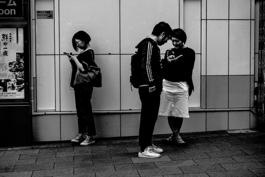 Persons watching smartphones
