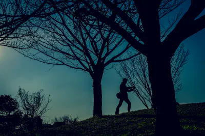 Silhouetted man taking photos in Saigoyama park