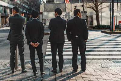 Businessmen waiting at red light