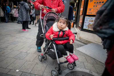 Little girl on a baby buggy