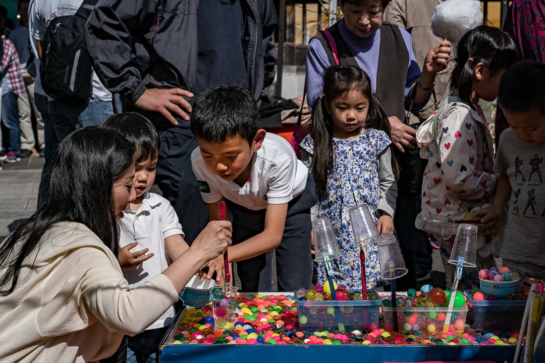 Parent and children playing at stall