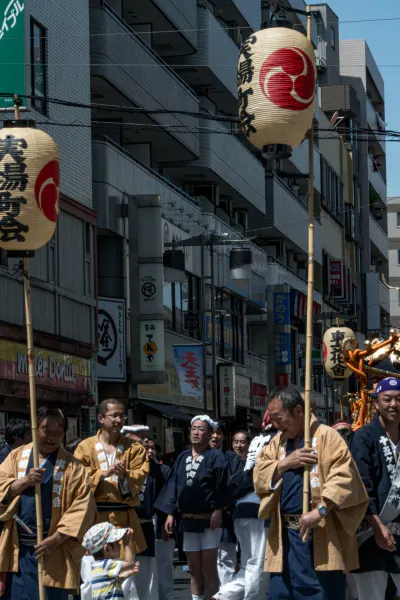 Man carrying long stick with lantern