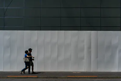 Couple in front of white fence