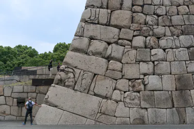 Man putting hand to stone wall