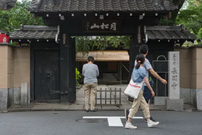 Praying man and passing couple