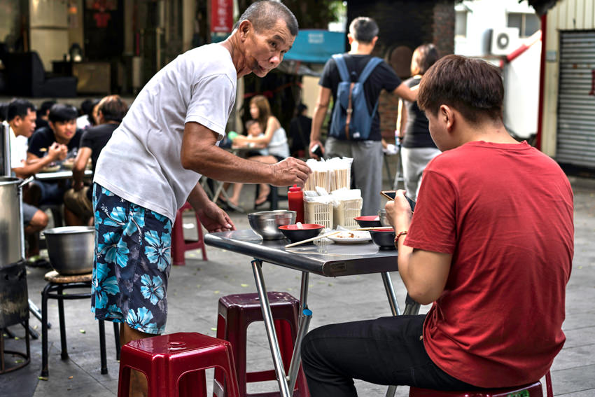 Man and staff in restaurant